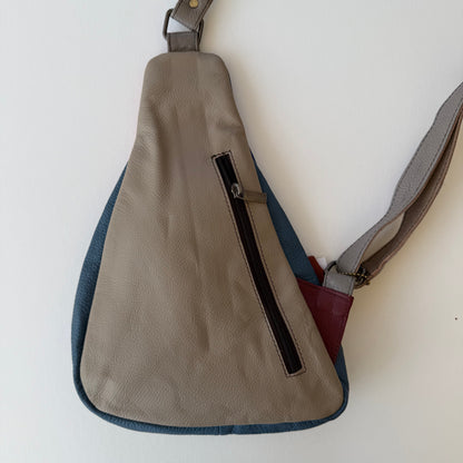 back view of Sling bag with a strap on a white background