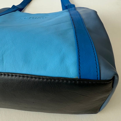 close-up of bottom of blue leather shoulder bag