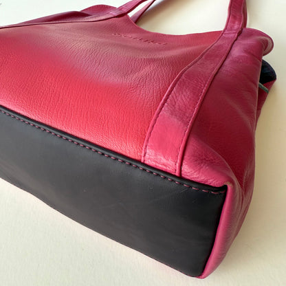 close-up of bottom of pink leather shoulder bag