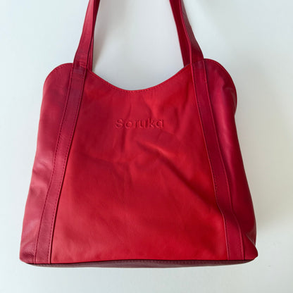 Red handbag with 'Soruka' branding on a white background