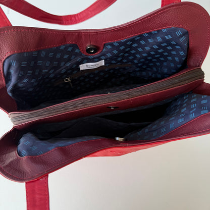 top view of red handbag showing interior with patterned lining