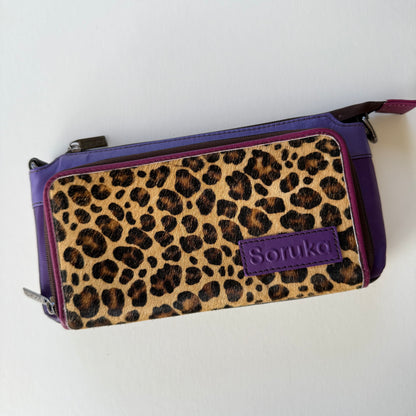 eggplant madison crossbody with purple body and cheetah print front pocket