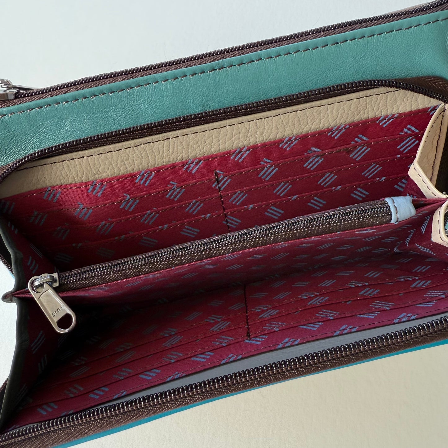 interior view of turquoise madison crossbody front pocket