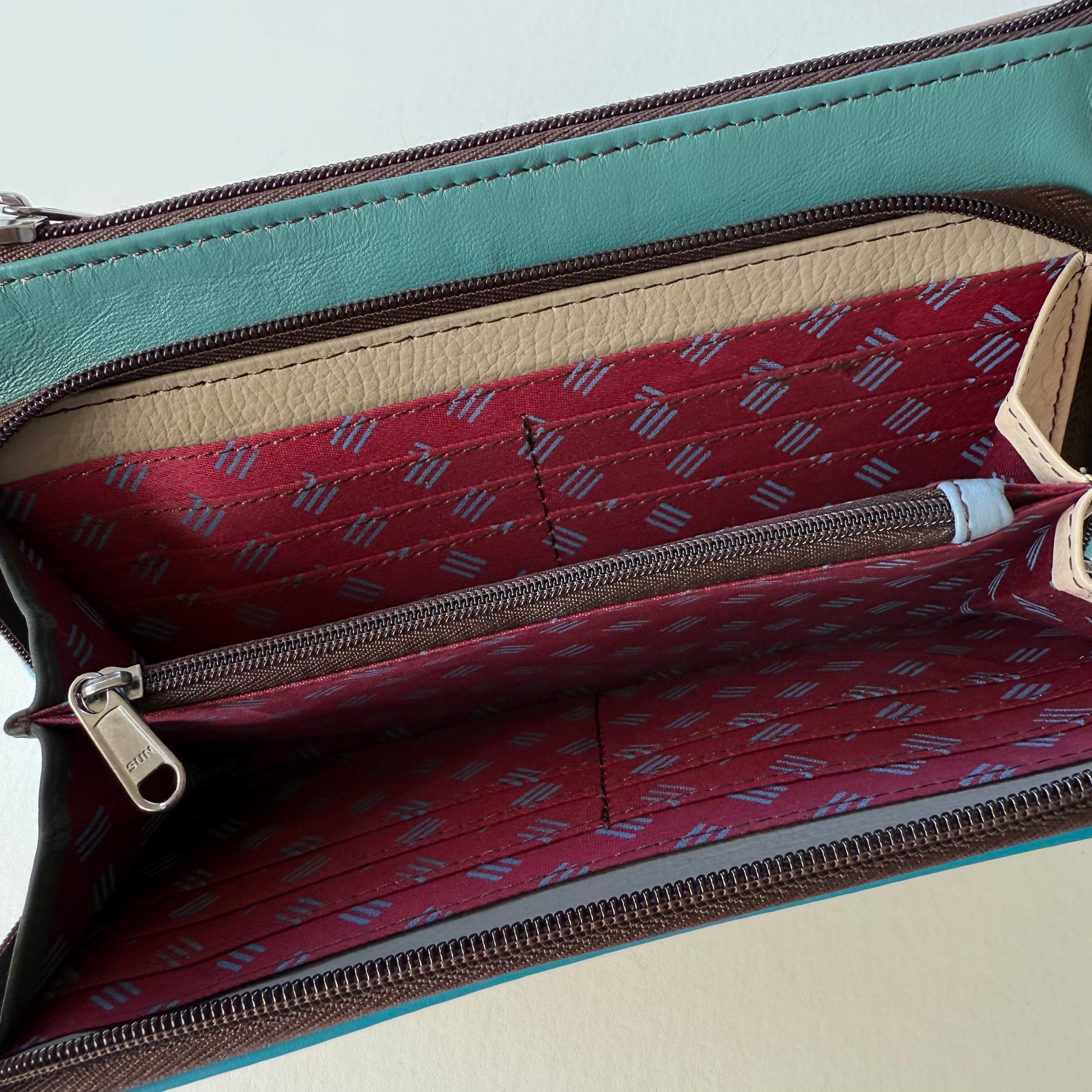 interior view of turquoise madison crossbody front pocket