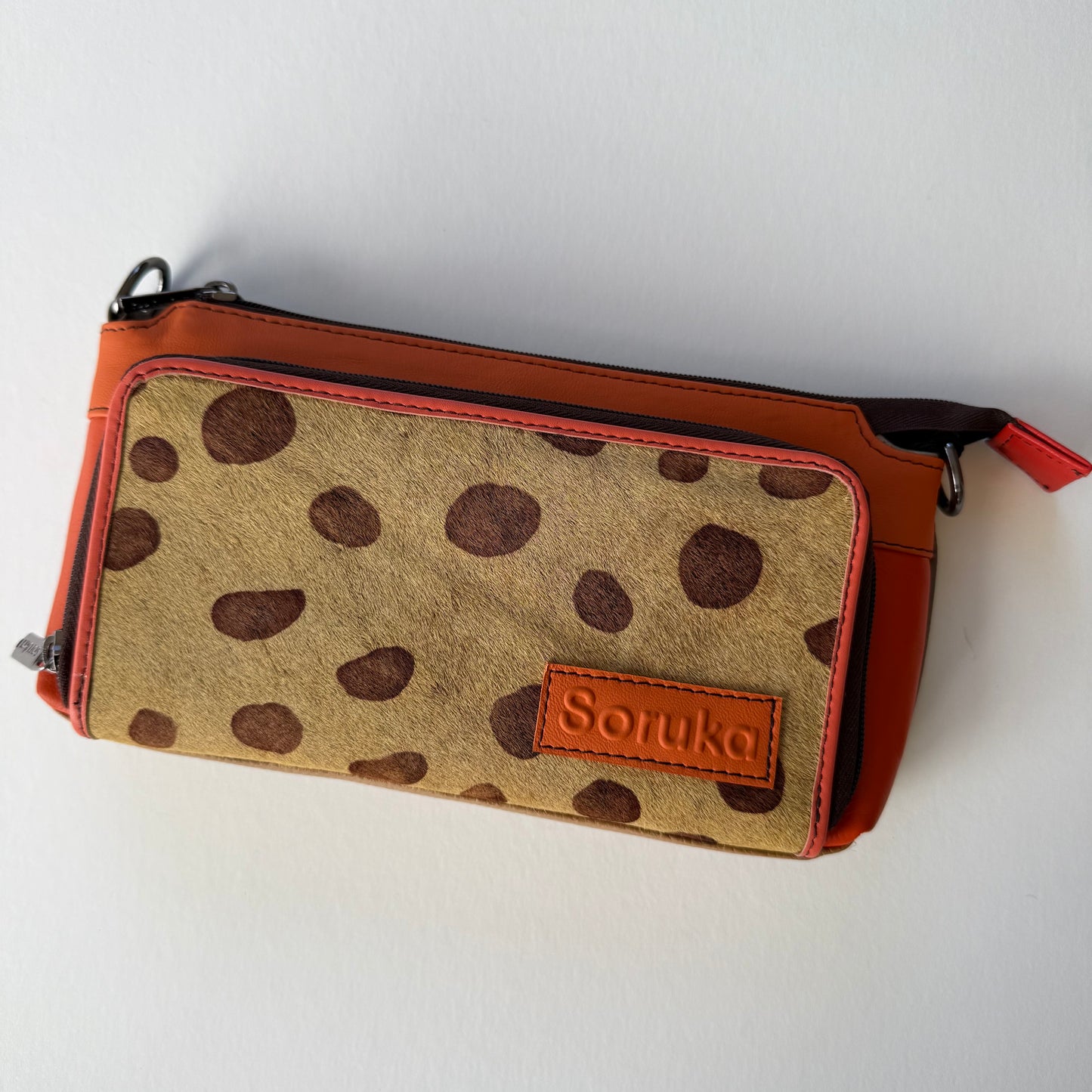 sunrise madison crossbody with orange body and brown on brown animal print front pocket