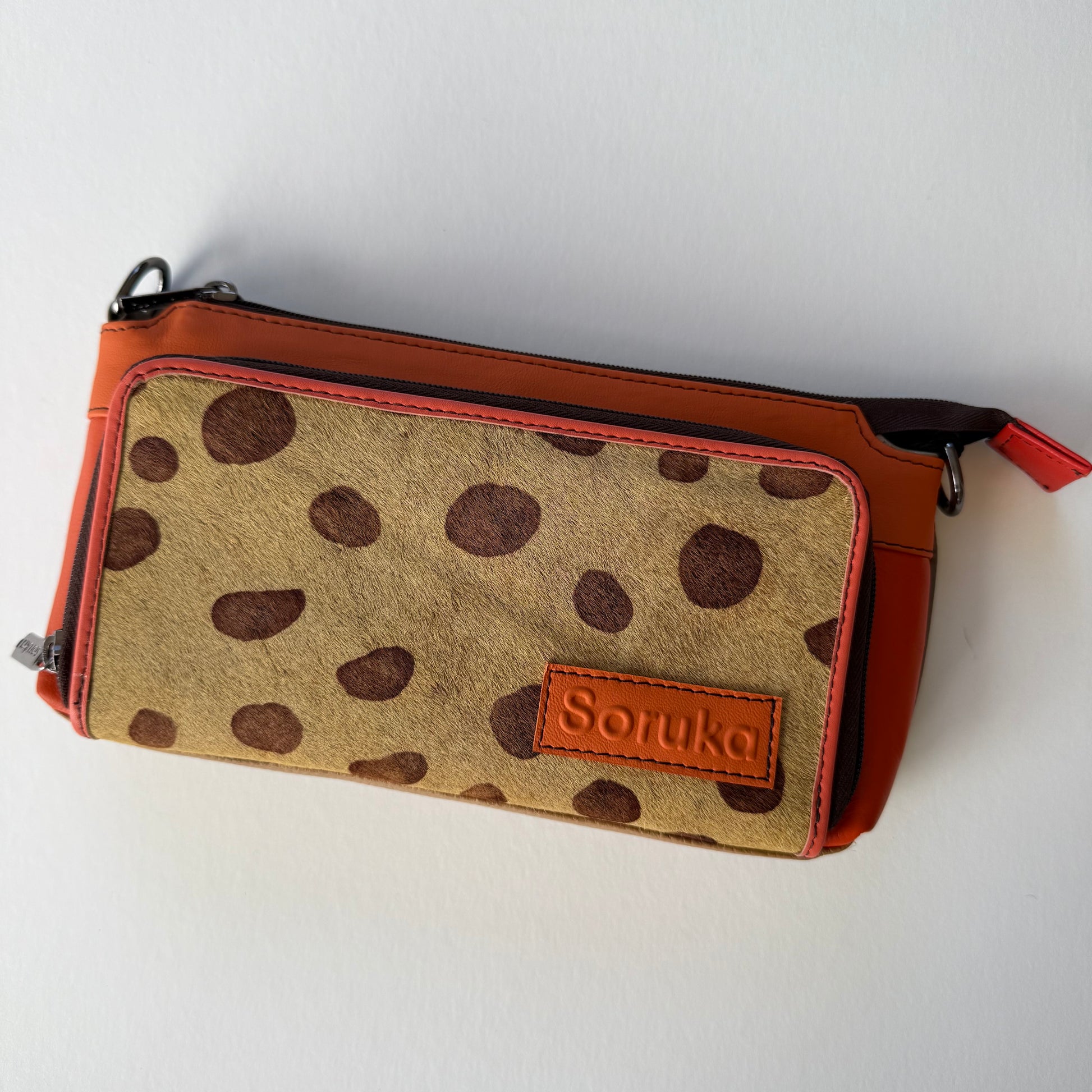 sunrise madison crossbody with orange body and brown on brown animal print front pocket