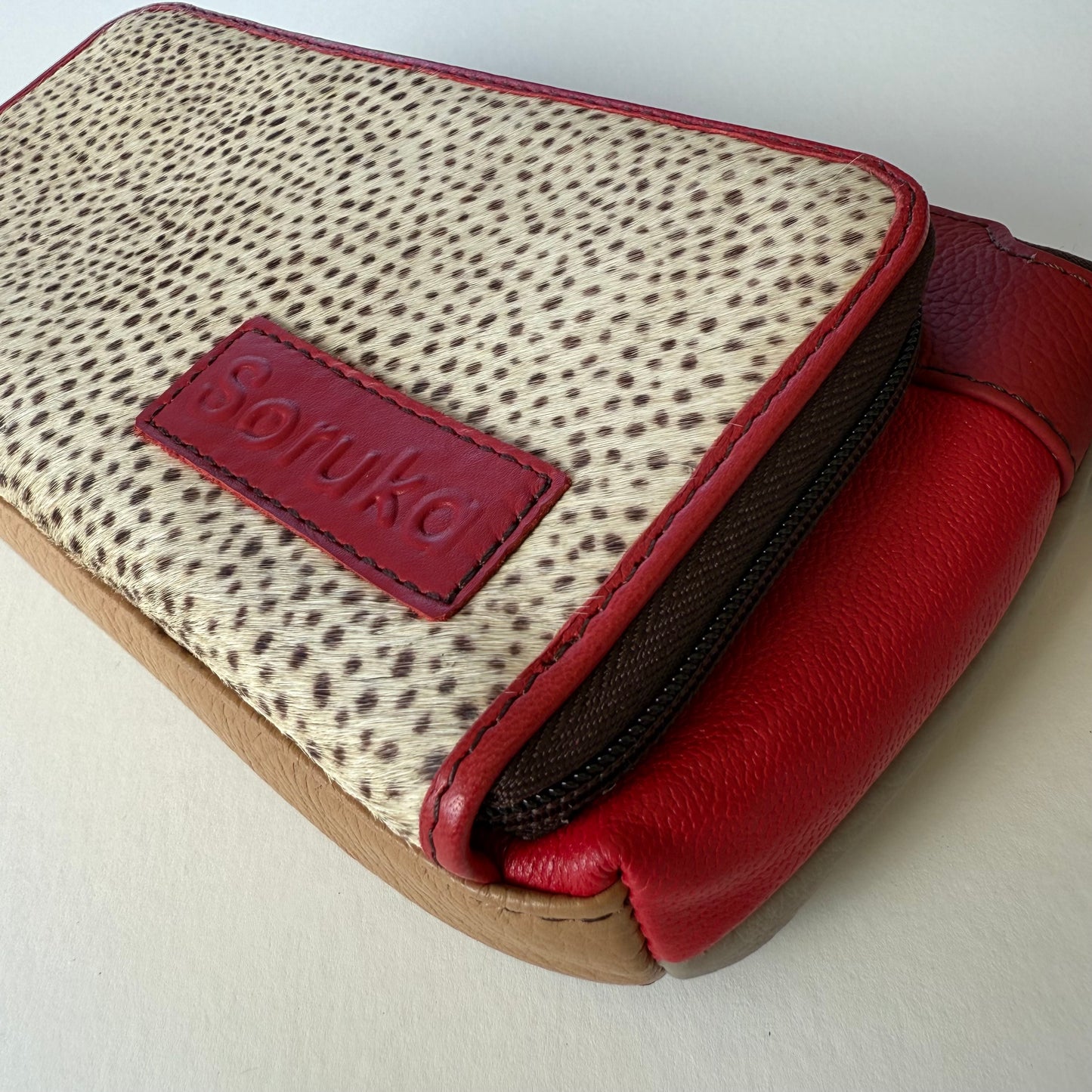 close-up of side view of cranberry madison crossbody