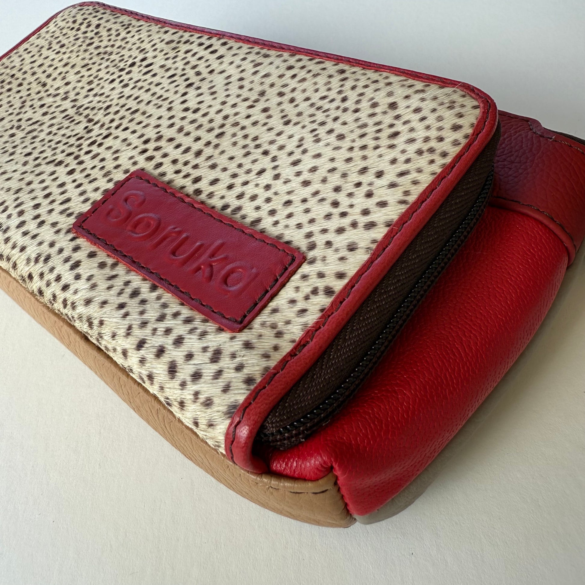 close-up of side view of cranberry madison crossbody