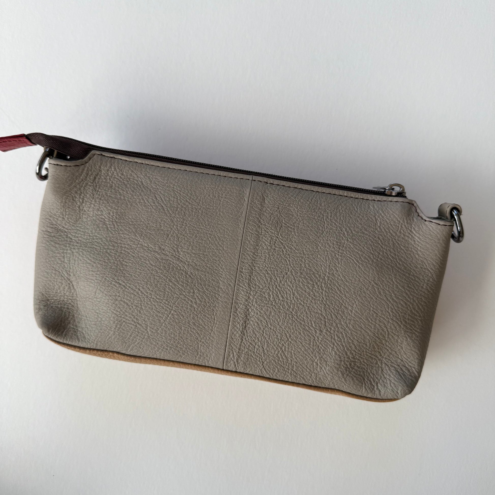 back view of cranberry madison crossbody with grey back
