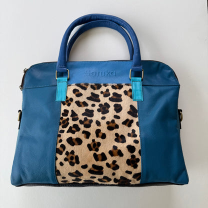 multi Blue handbag with leopard print panel on a white background