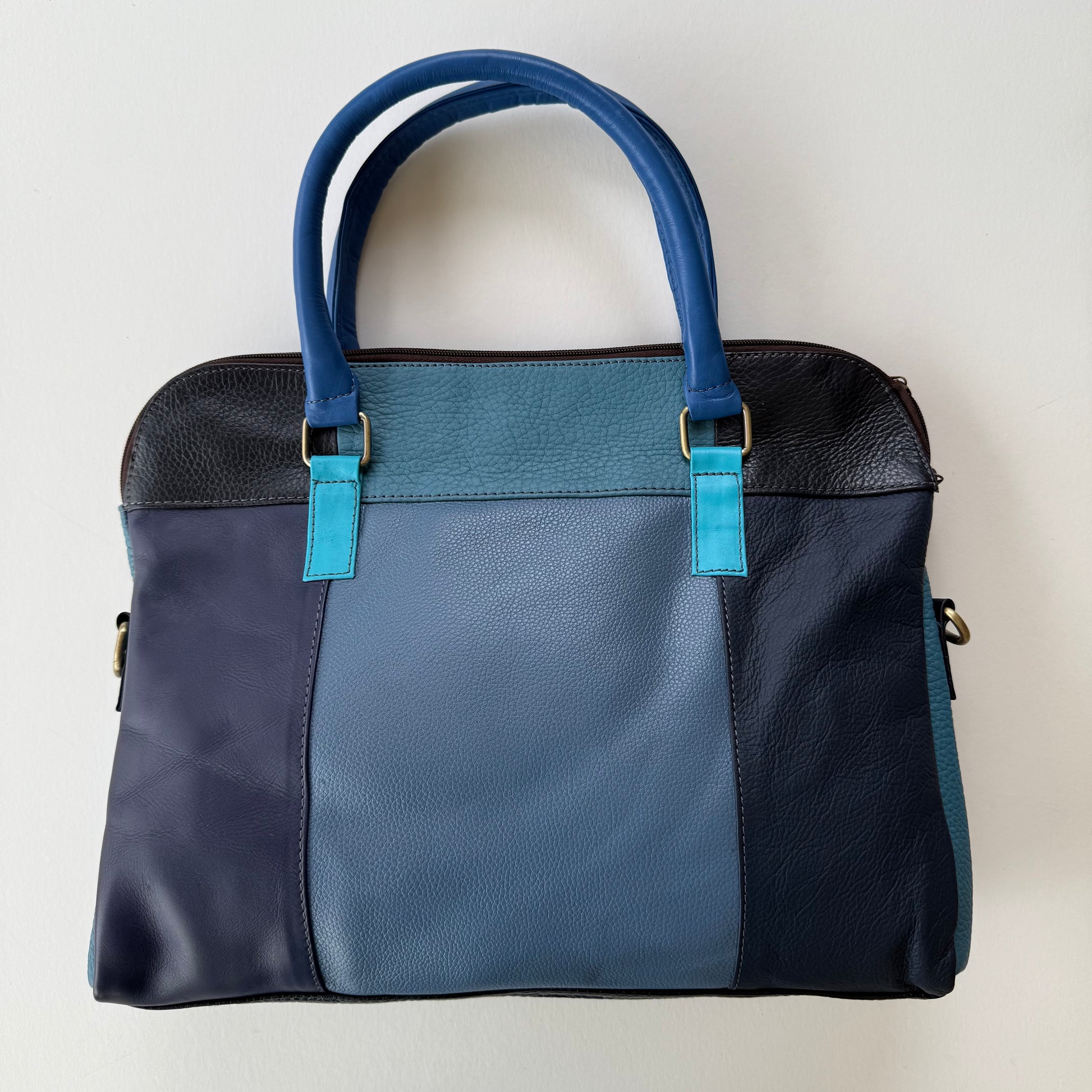 back view of Two-tone blue handbag with a white background