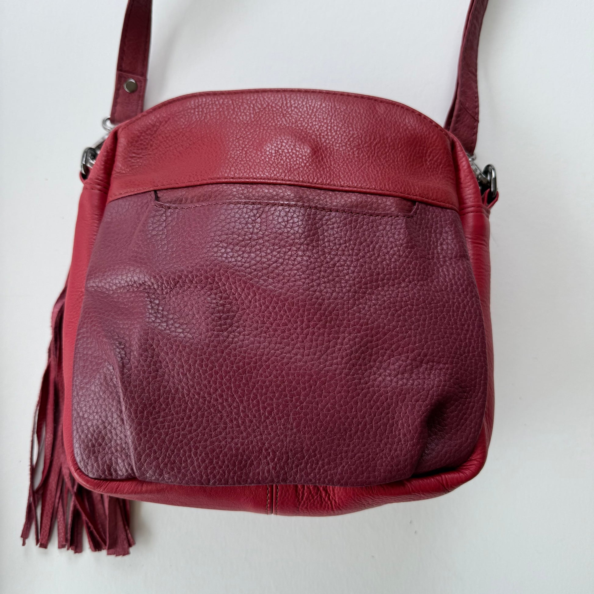 back view of Red leather handbag on a white background