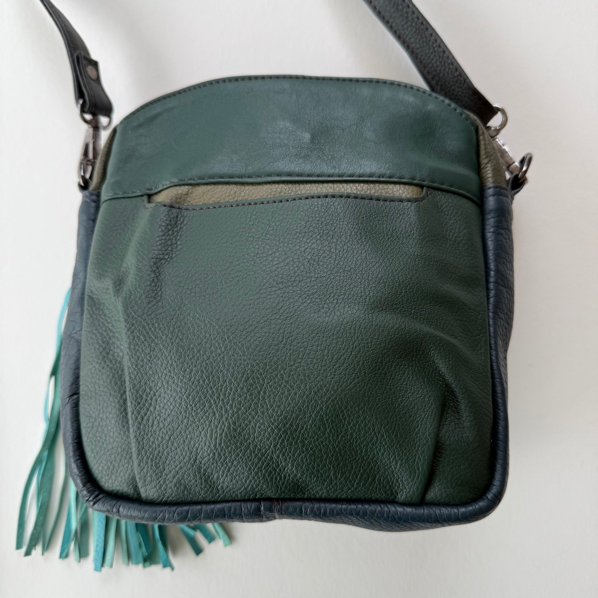 back view of handbag with dark green backing