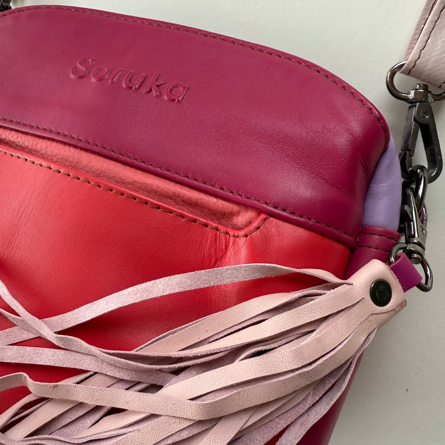 top view of pink handbag with pocket and tassel