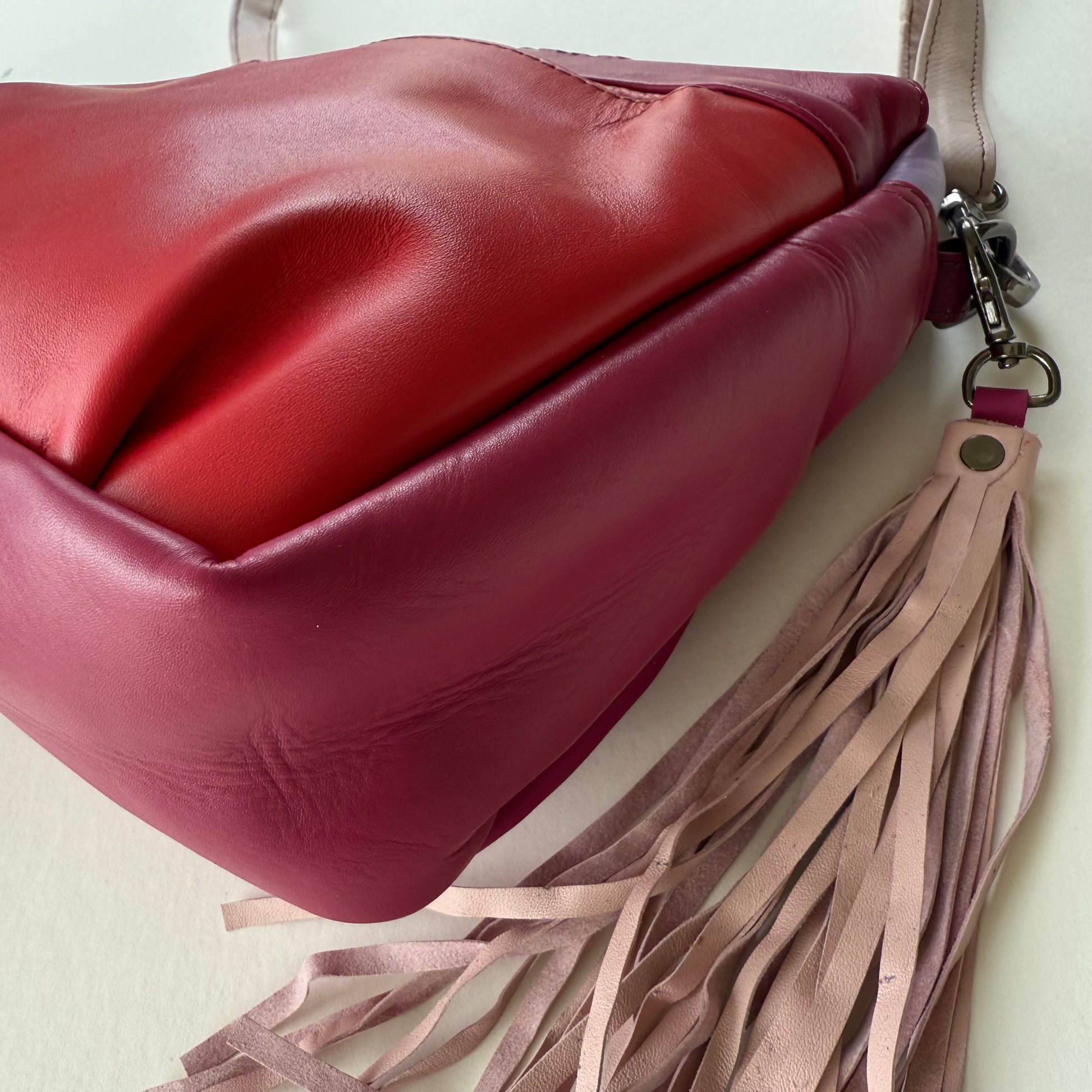 bottom view of pink handbag with light pink tassel