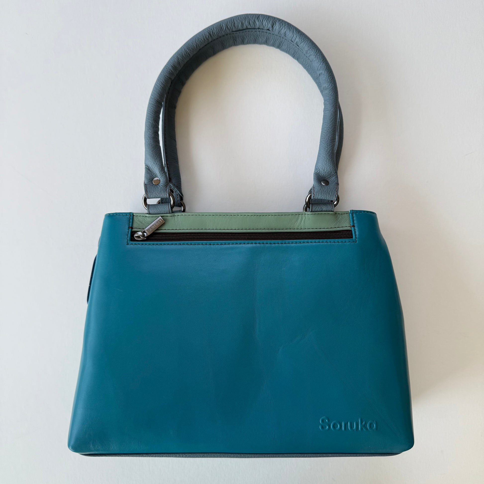 turquoise handbag on a white background