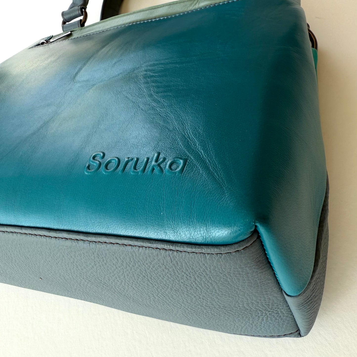 bottom view of turquoise handbag