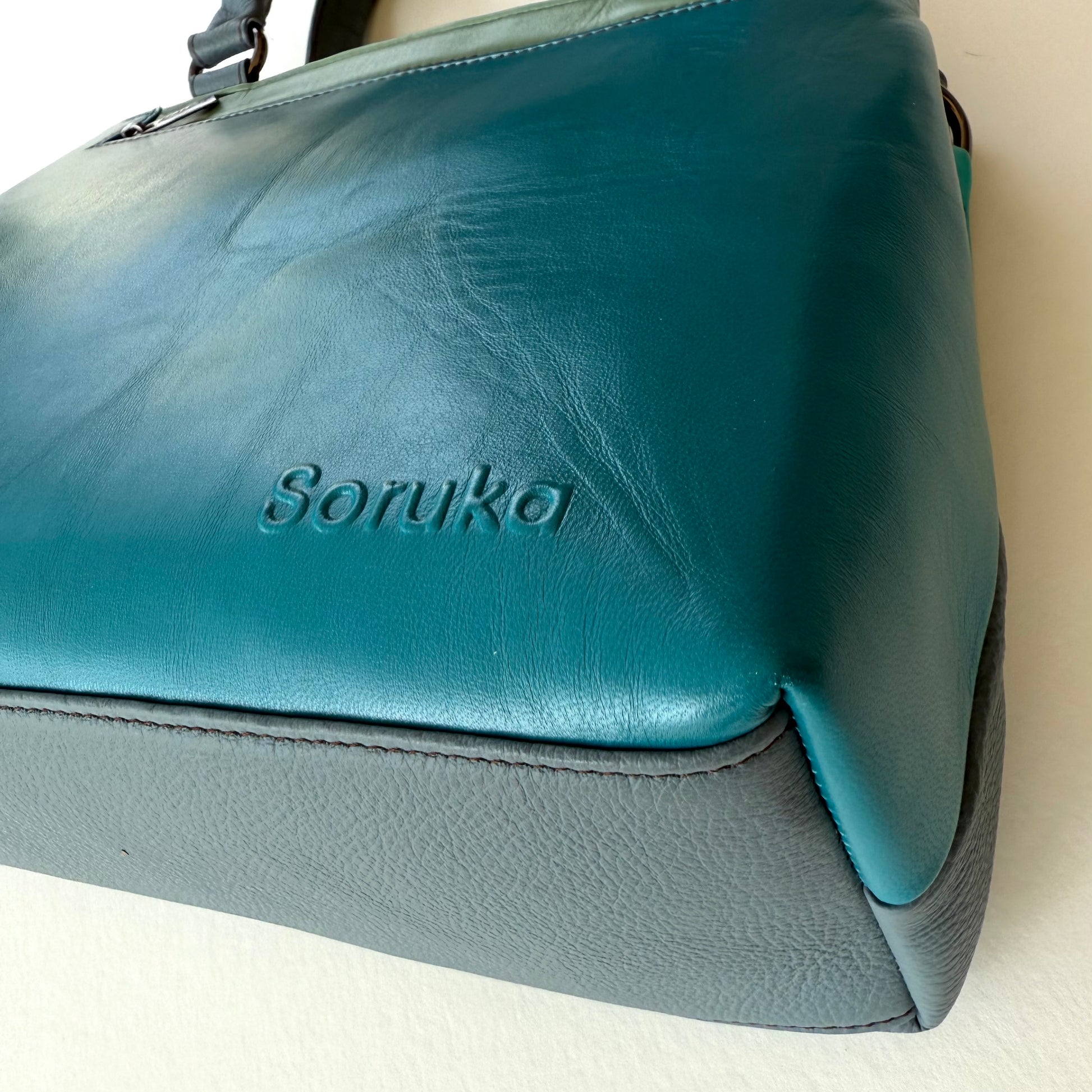 bottom view of turquoise handbag
