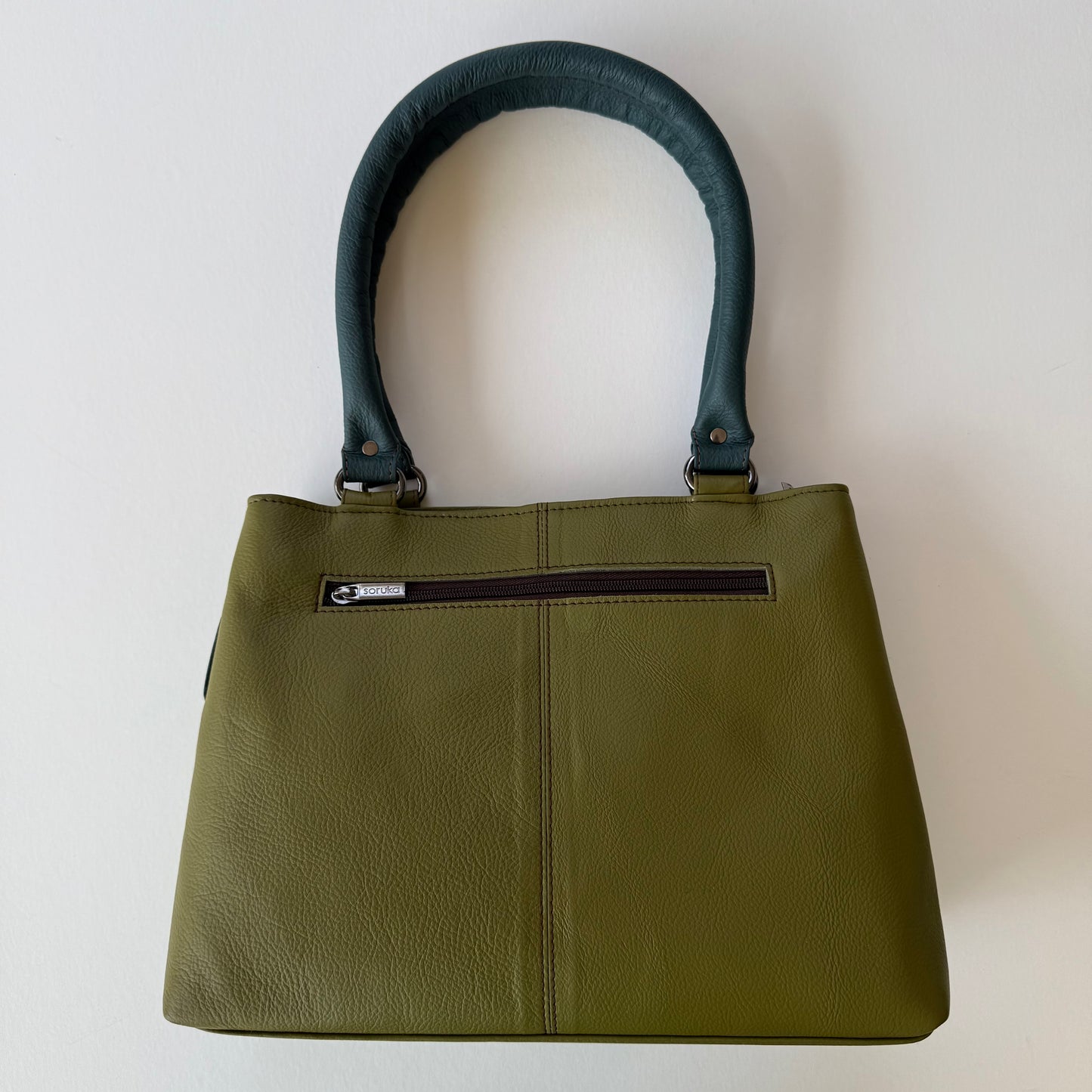 back view of green leather handbag