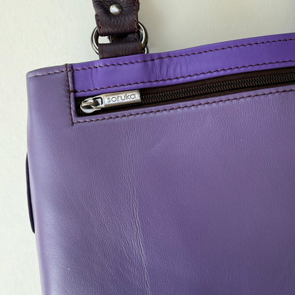 close-up of Purple handbag with a closed zipper pocket