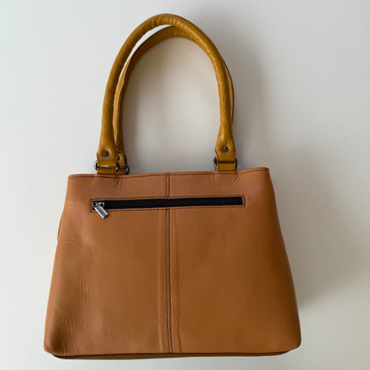 back view of handbag with beige leather  backing