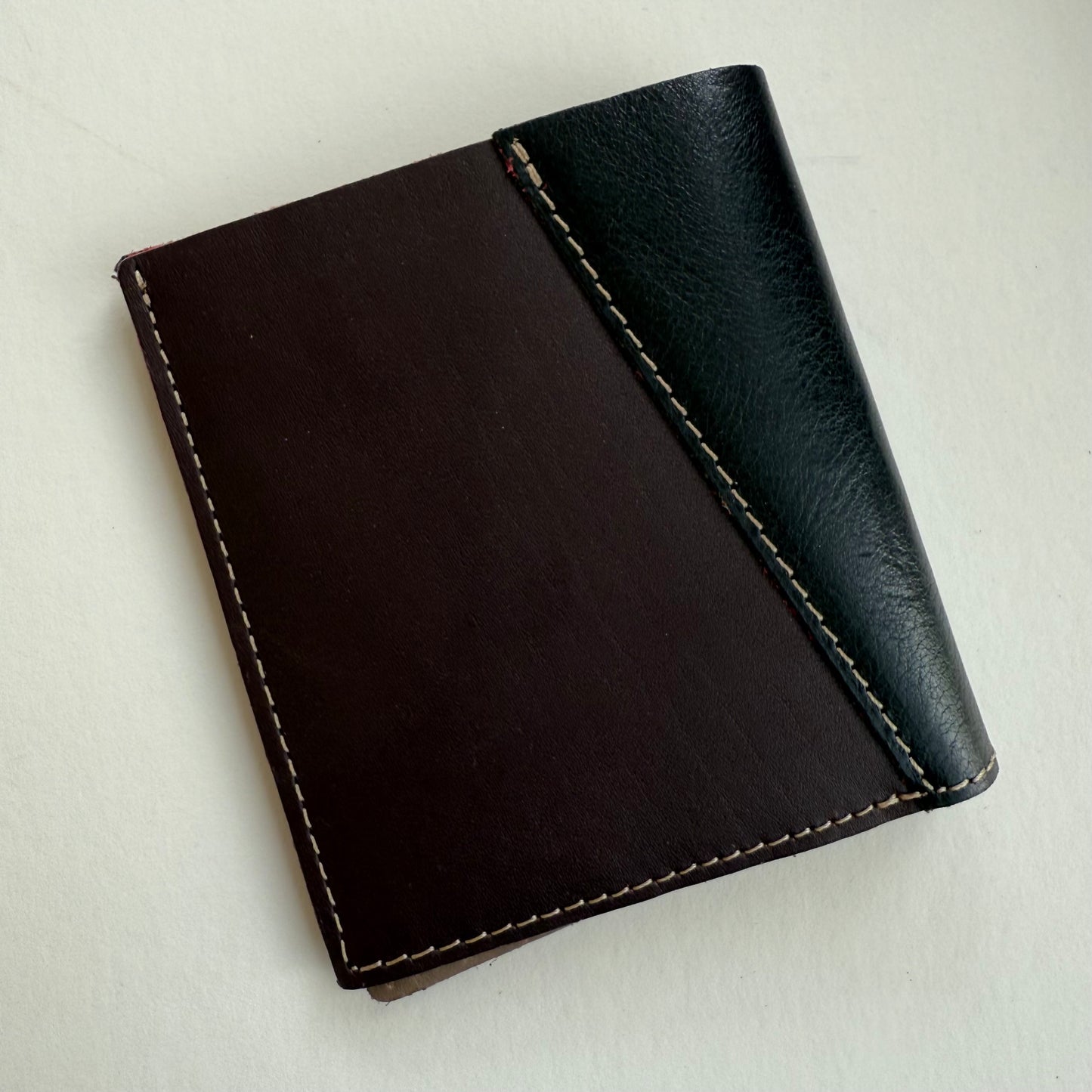 brown and Black leather wallet on a light gray background