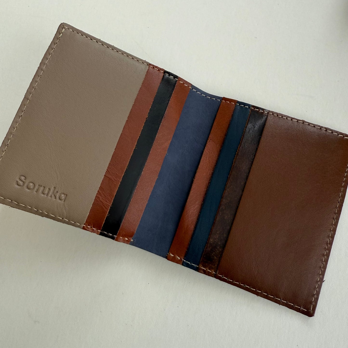 interior view of wallet with multi-colored card slots in various brown and blue hues