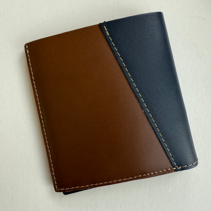 Two-tone brown and blue leather wallet on a light gray background