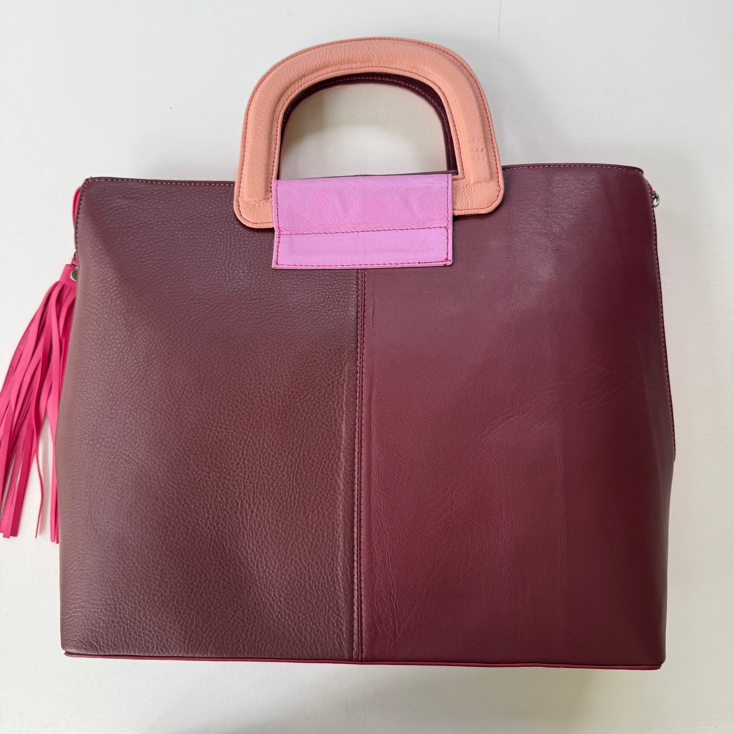 back view of tote back win shades of burgundy with pink tassel