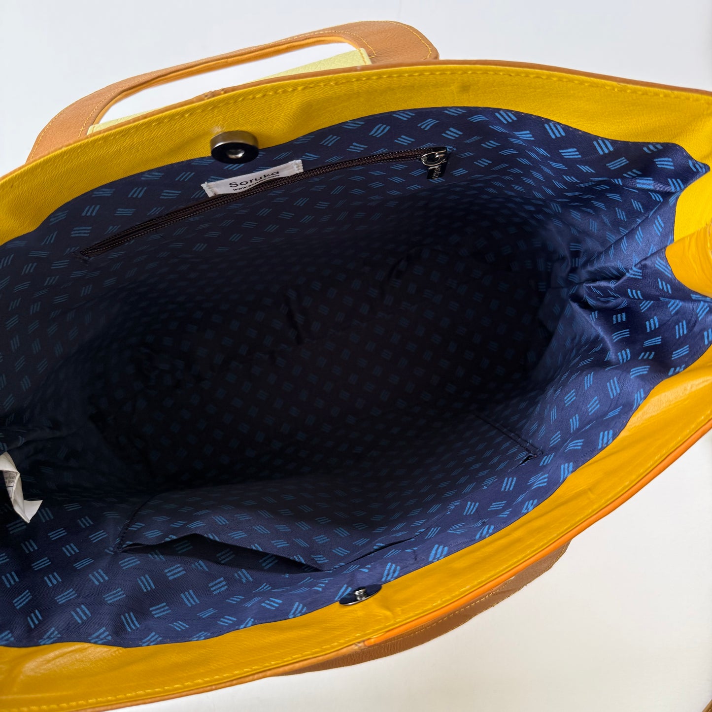 interior view of tote bag with navy patterned lining and pockets