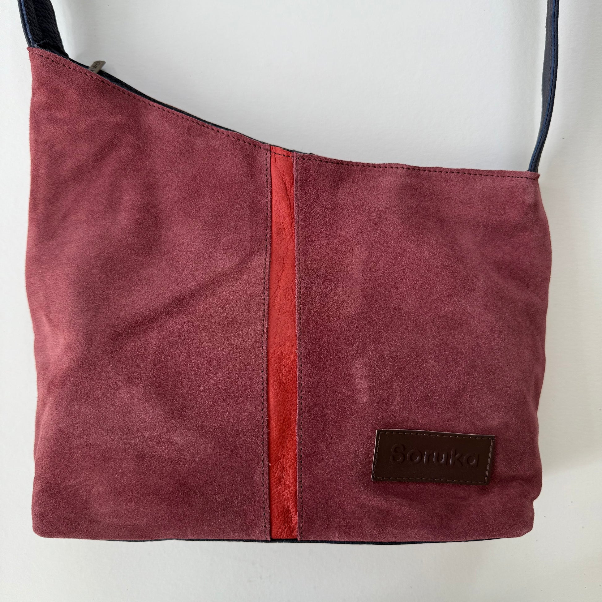 Maroon handbag with a red stripe down the middle