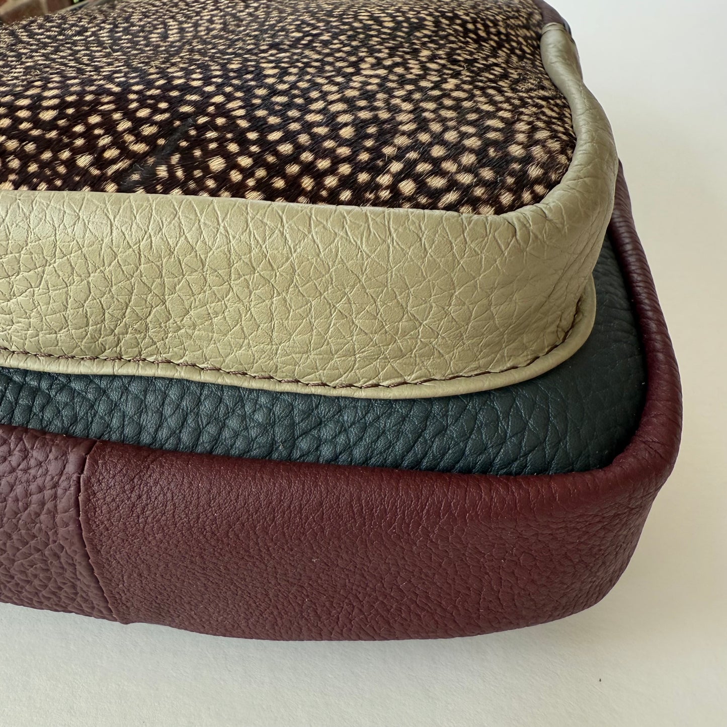 close-up of bottom of multi-colored sling bag