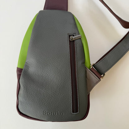 back view of grey sling bag with zippered pocket