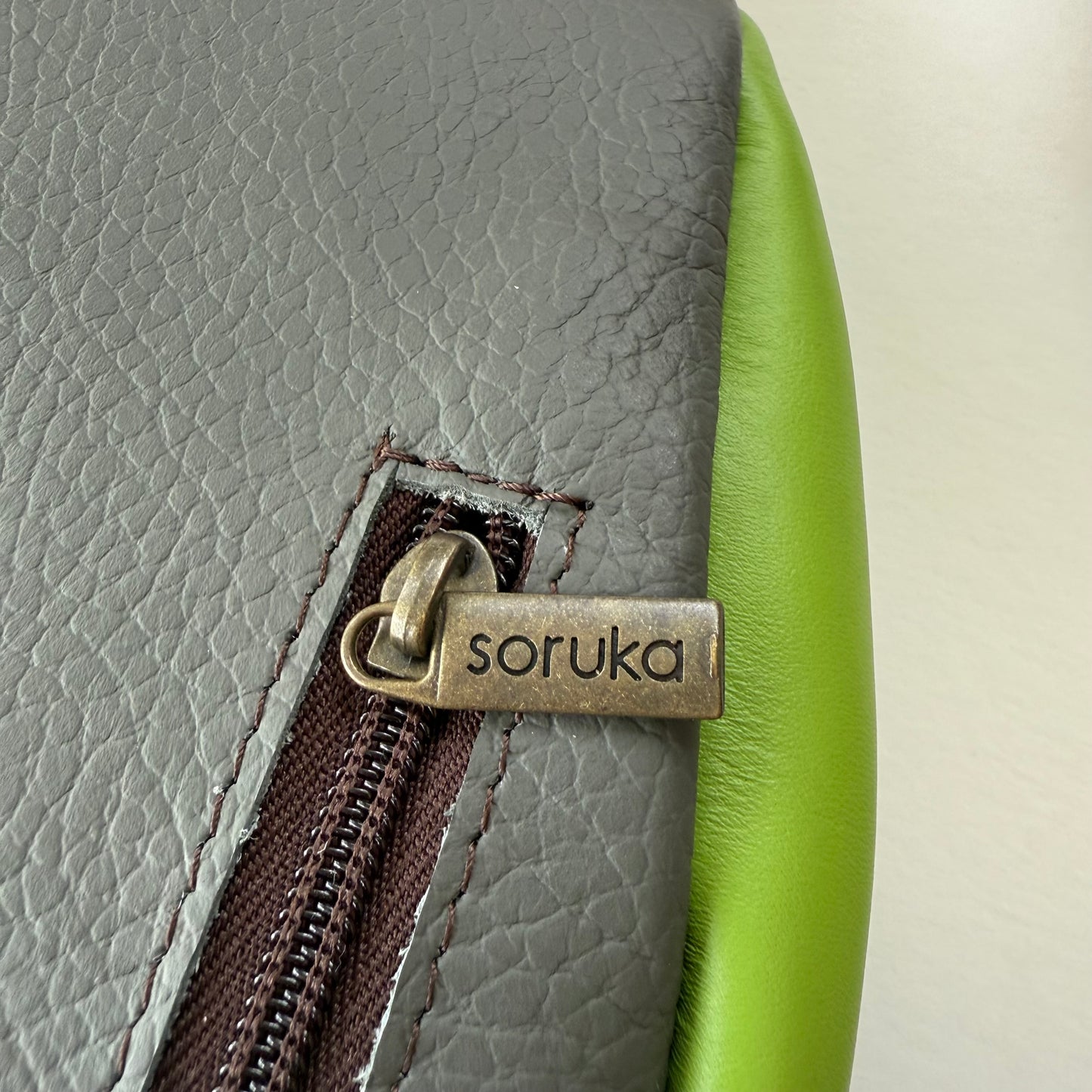 close-up of zipper pocket on back of sling bag