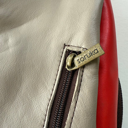 close-up of zipper pocket on back of sling bag