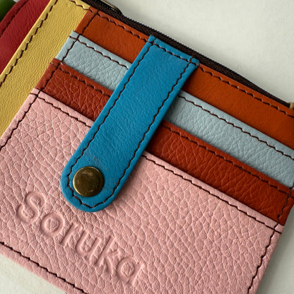 close-up of wallet with snapped tab over colorful card slots
