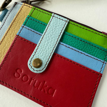 close-up of wallet with snapped tab over colorful card slots
