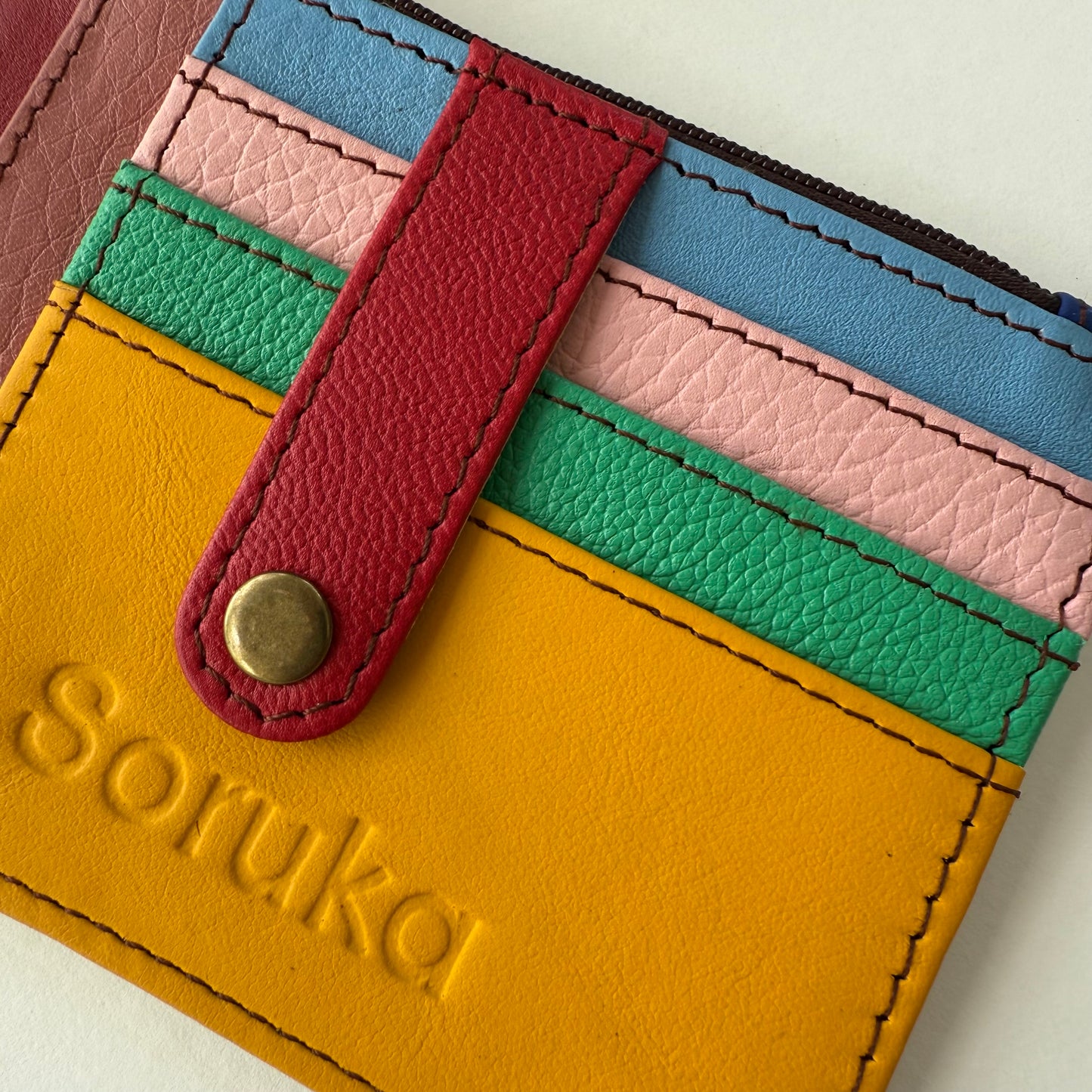close-up of wallet with snapped tab over colorful card slots