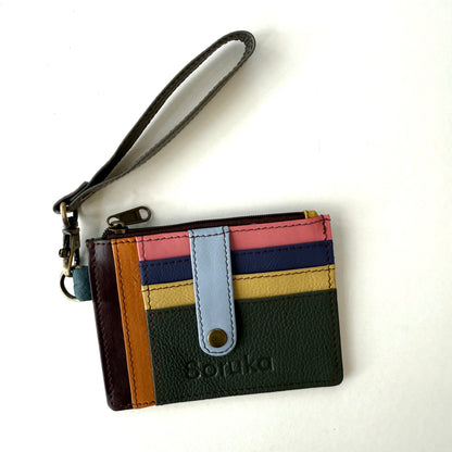 small wallet with colorful card slots, a light blue tab, and dark wristlet strap
