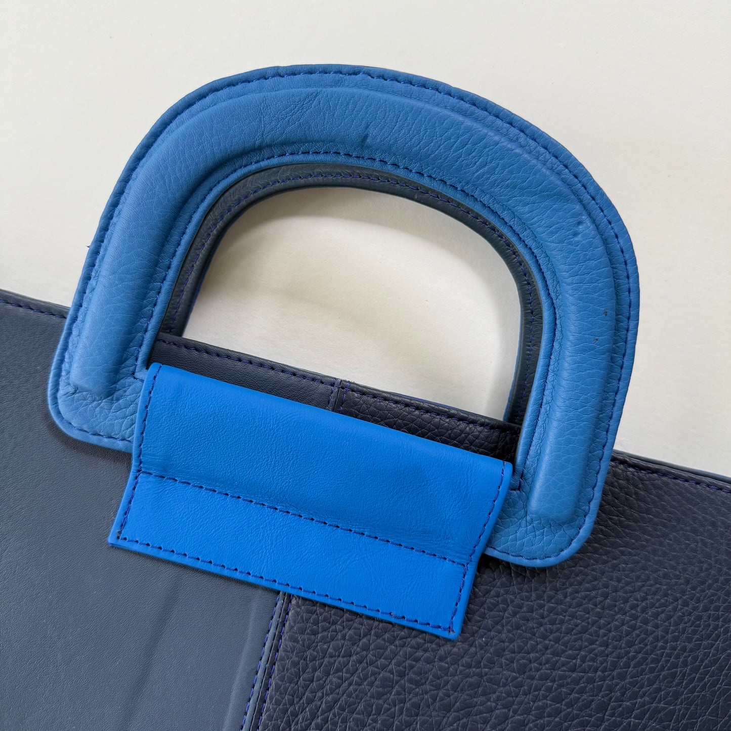 close-up of bright blue handle on blue tote bag