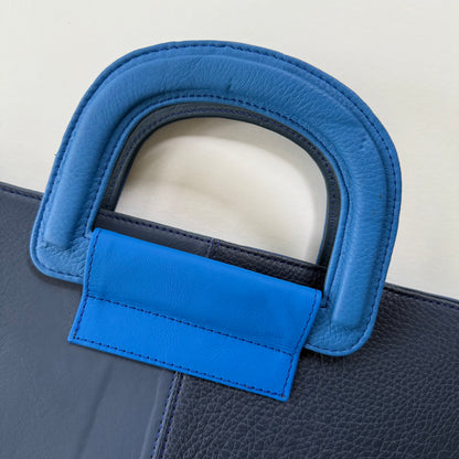close-up of bright blue handle on blue tote bag