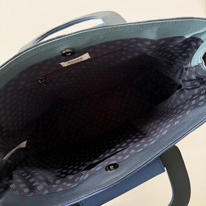 interior view of tote bag with navy patterned lining and pockets