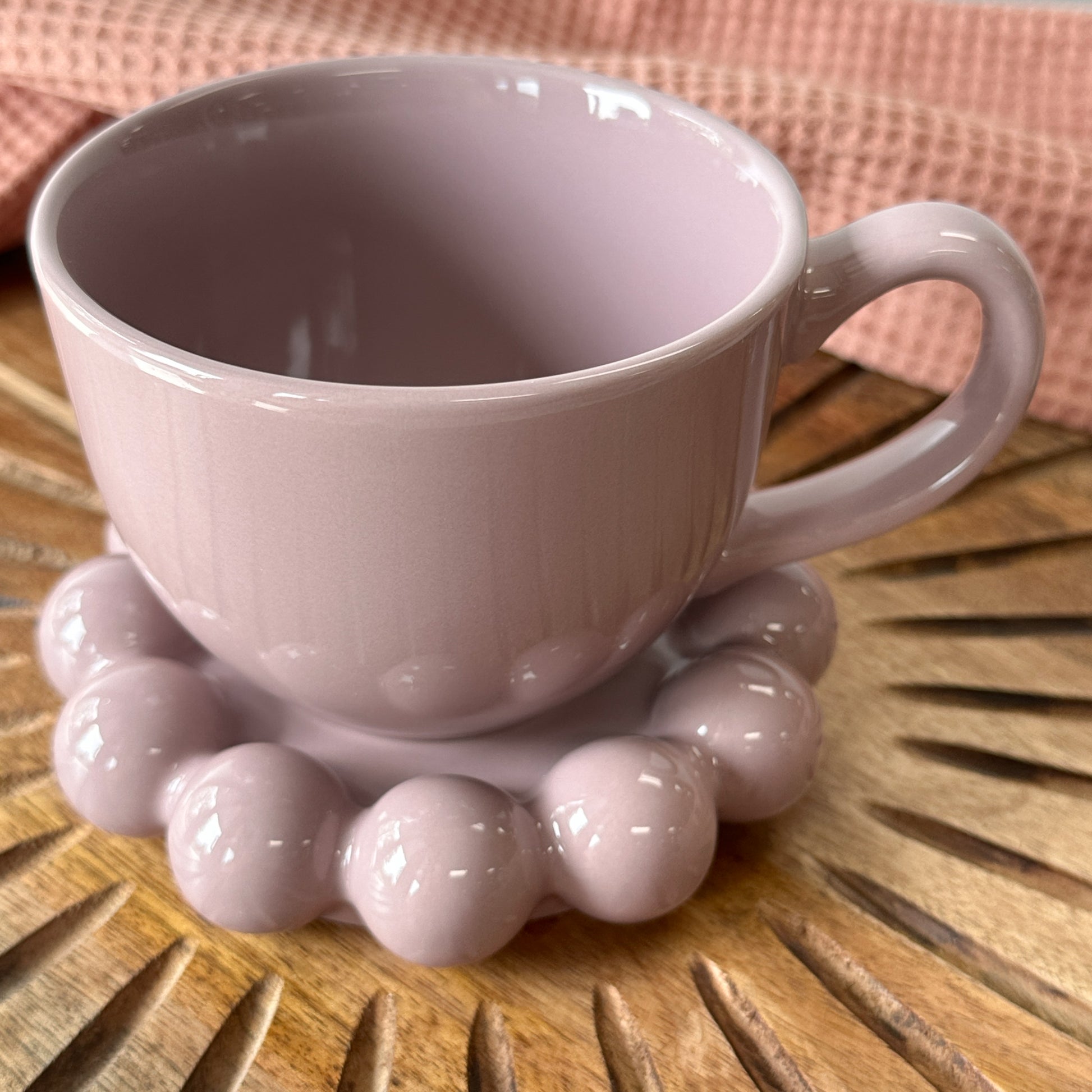 lavender Stoneware Mug with Bubble Saucer set on a wooden board