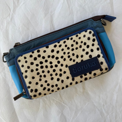 small blue crossbody with white and black dotted animal print front pocket