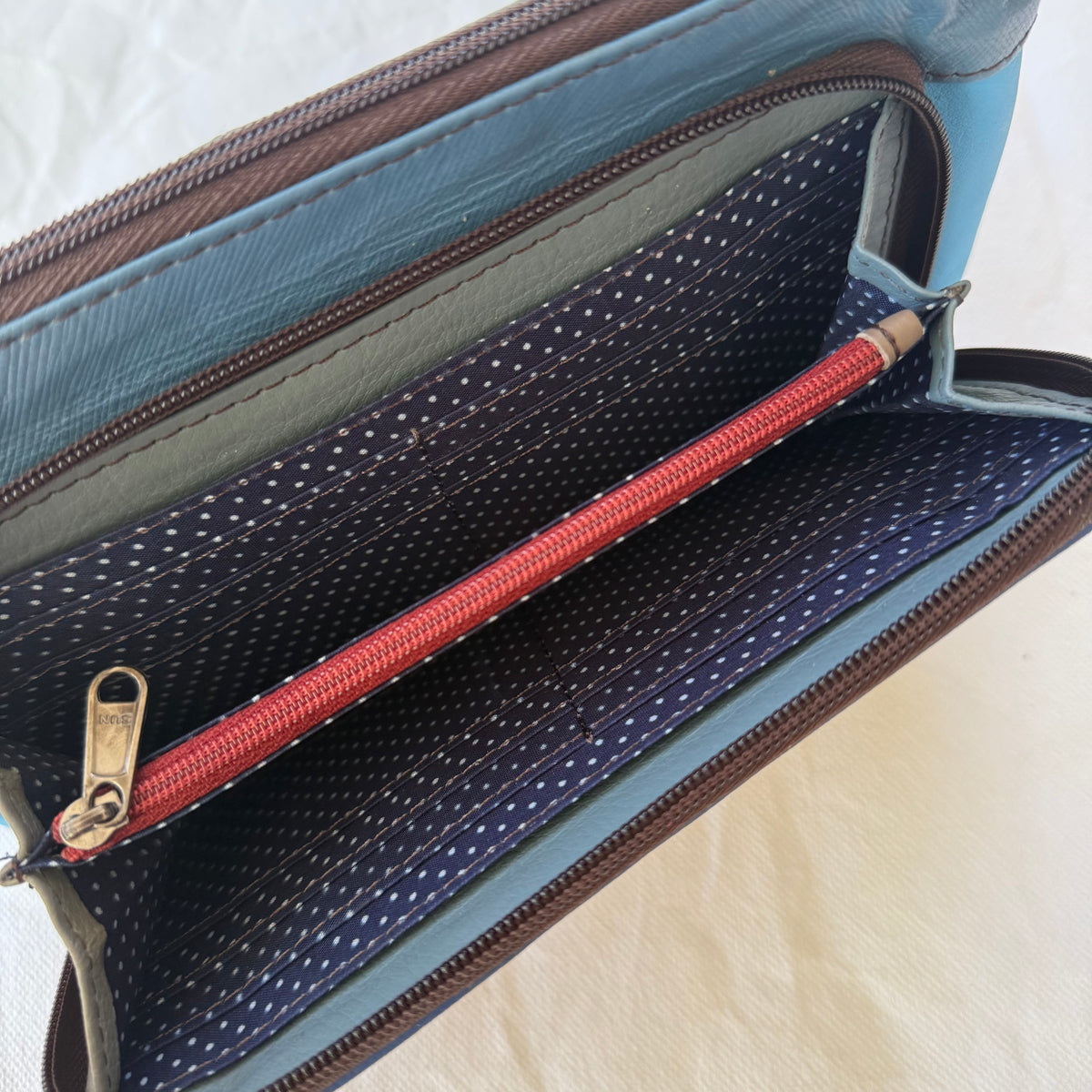interior view of front pocket showing card slots and zippered pocket