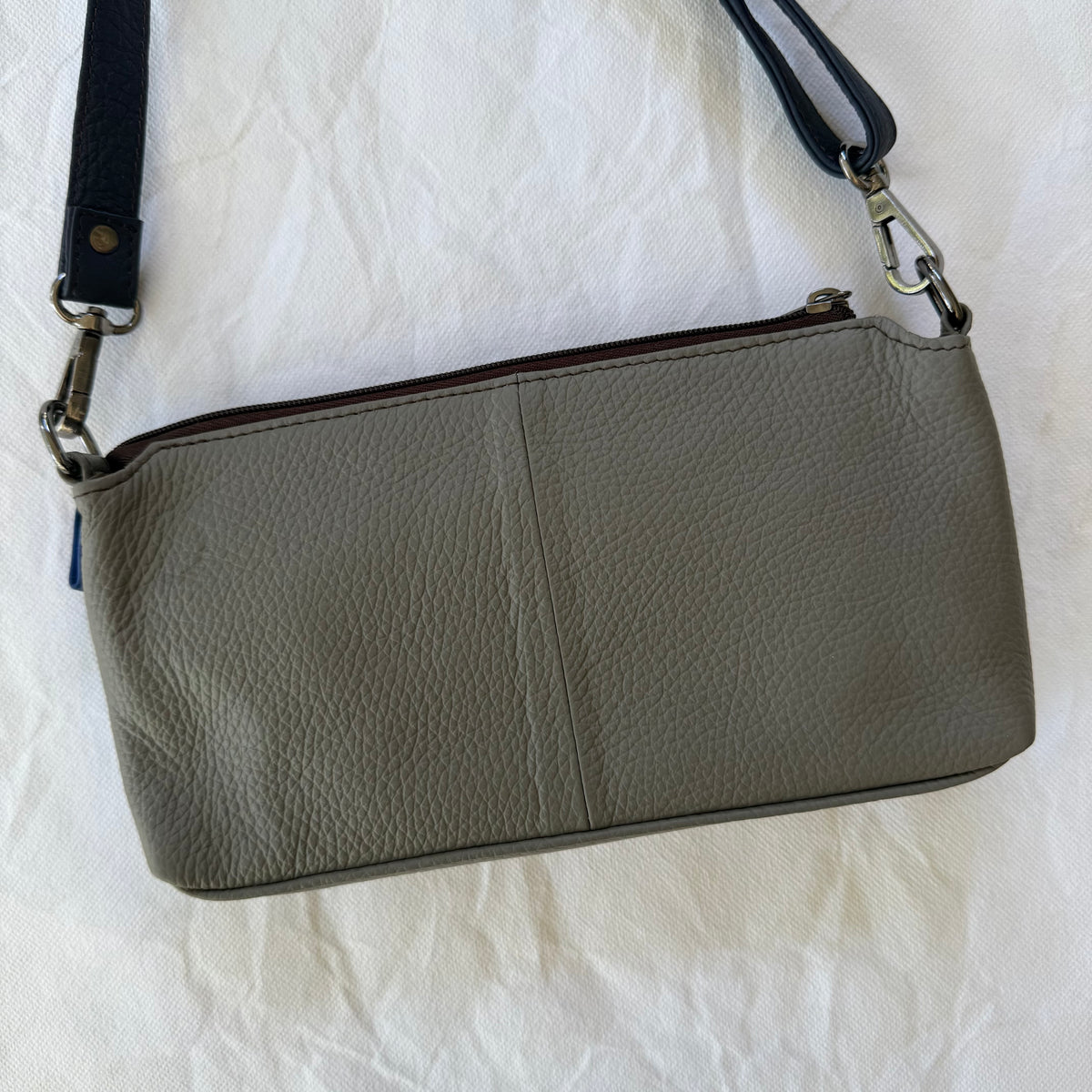 back view of small crossbody with grey backing