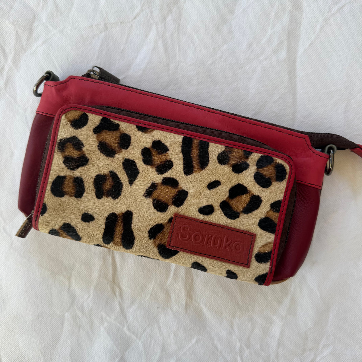 small red crossbody purse with leopard print front pocket