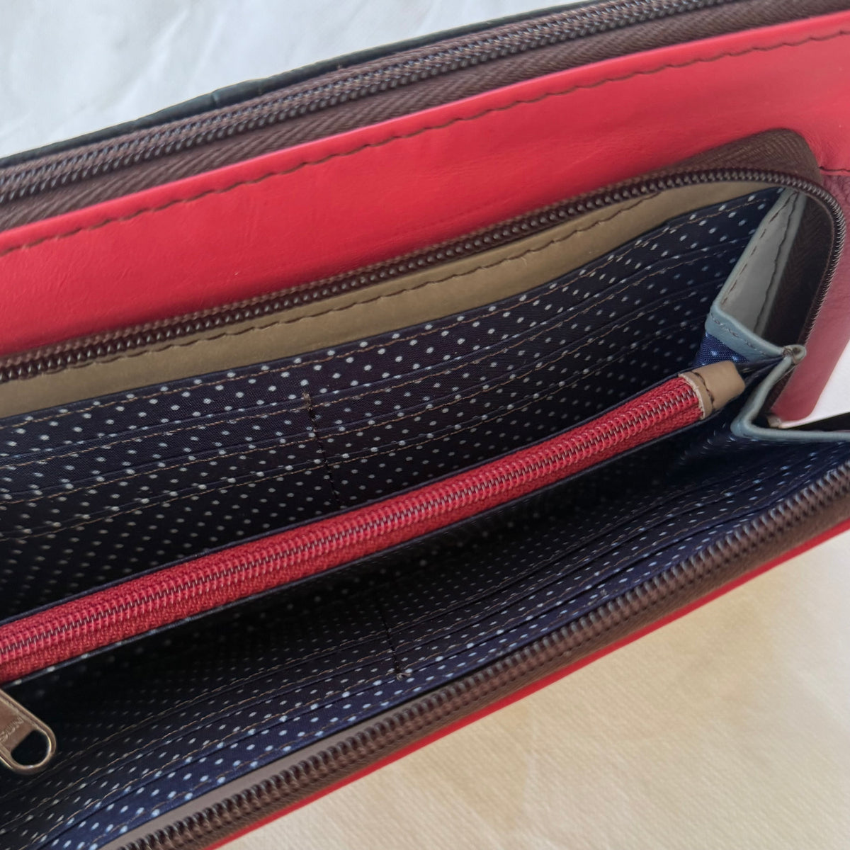 interior view of front pocket of small crossbody showing card slots and zippered pocket