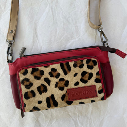 small red purse with taupe crossbody strap