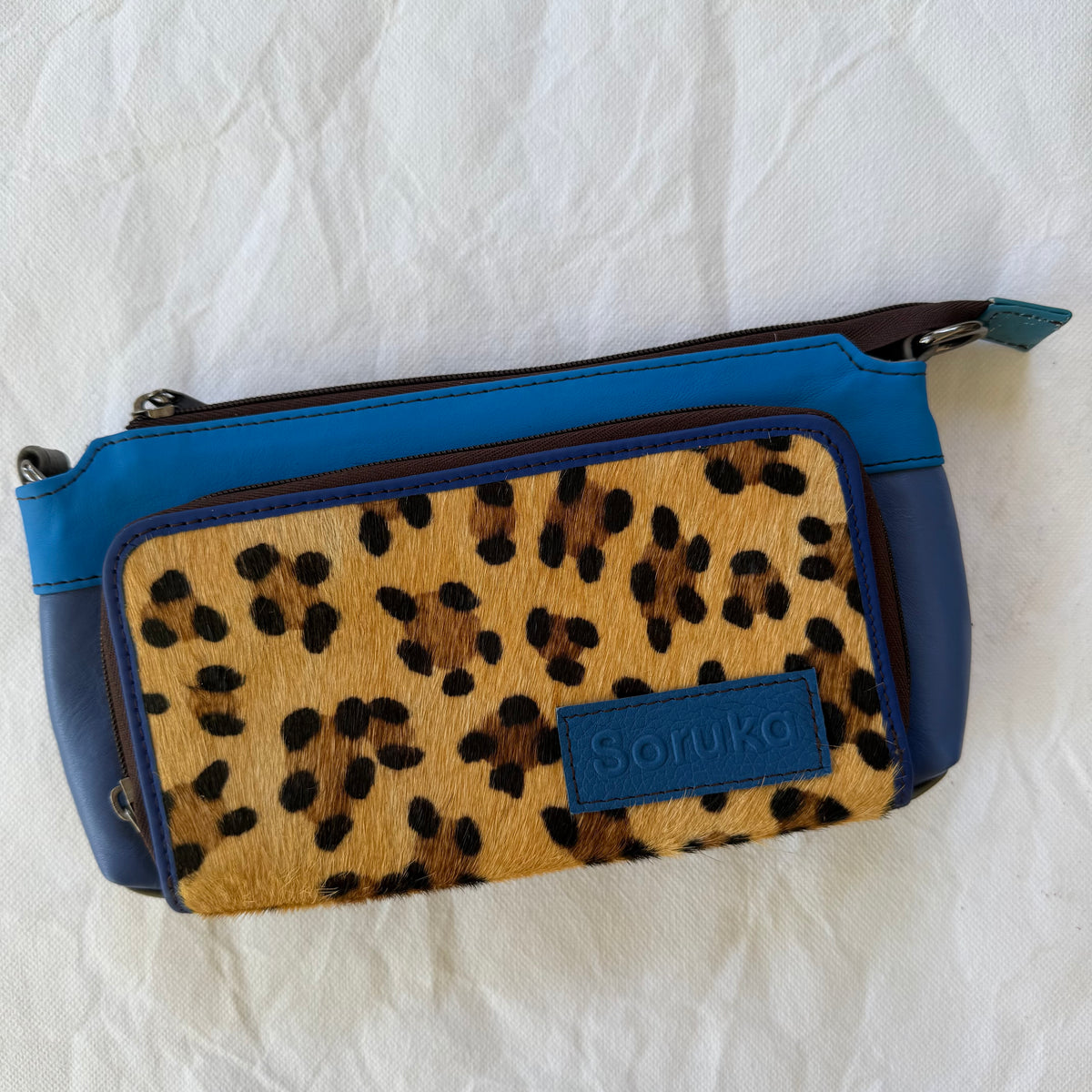small bright blue crossbody with leopard front pocket